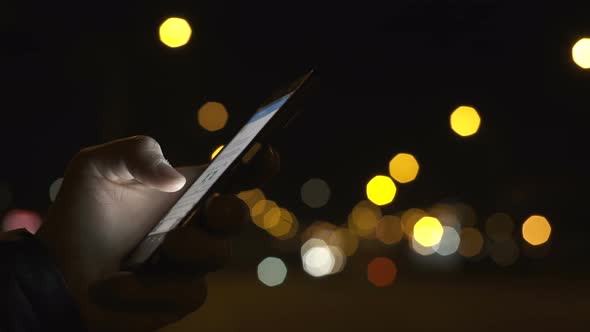 Using Smart Phone On Night Street