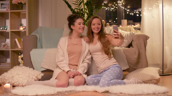 Female Friends Taking Selfie By Smartphone at Home