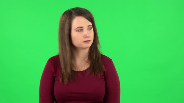 Portrait of Pretty Girl Is Gesturing Expressing Irritation and Anger. Green Screen