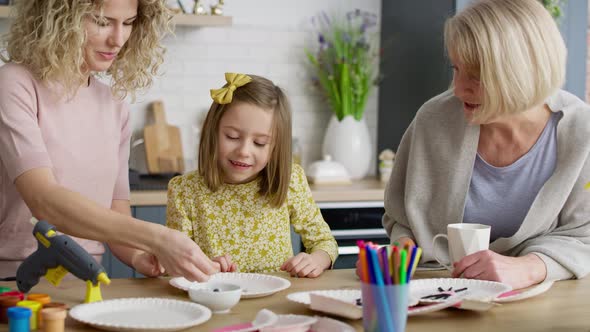 Video of three generations of women making handmade Easter decorations