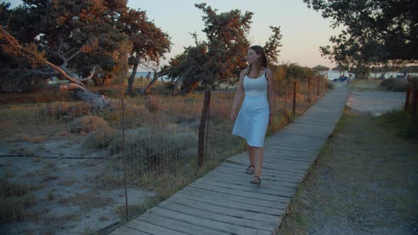 Beautiful Woman Walking On Sandy Beach