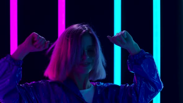 Portrait of a Young Stylish Woman in Sunglasses in Sunglasses Dancing To Fast Music. Close Up. Slow