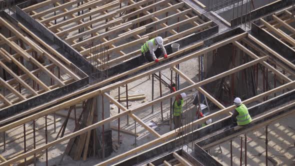 Builders Reinforce Formwork On Construction Site