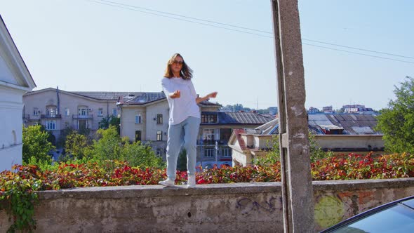 Girl Performing Modern Dances on Retaining Wall