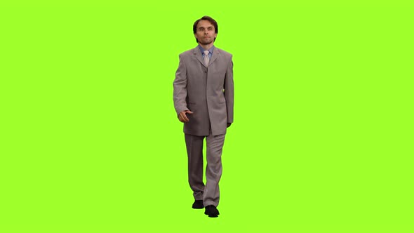 Businessman in Suit Walks on Green Background, Chroma Key