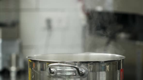 Vapour Clouds Rising From Boiling Water in Pan on Stove