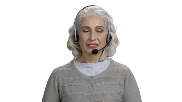 Happy Mature Woman in Headset Talking to Camera