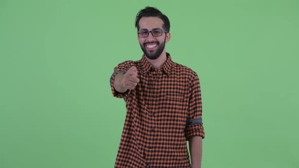 Happy Young Bearded Persian Hipster Man Pointing at Camera