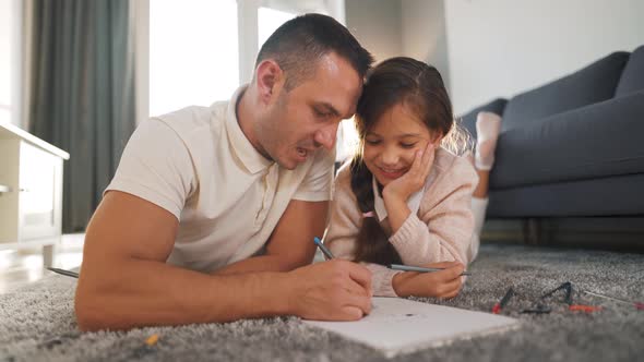 Father and Daughter Communicate Having Fun and Painting Together