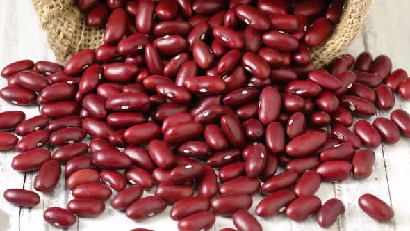 Dried red beans from a burlap bag close up full frame 