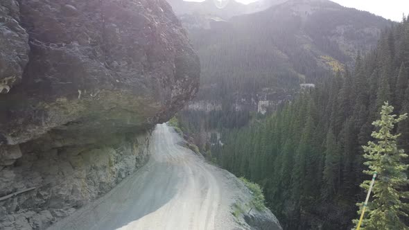 Aerial Looking Over Edge From Extremely Dangerous and Narrow Gravel Road on Edge of Cliffs in