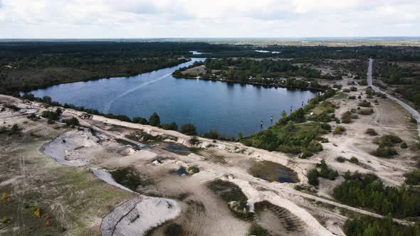 A Pond with Channels Surrounded By Trees and Boat Station on the Side