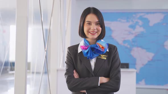 Portrait of beautiful Caucasian flight attendant staff smiling and looking at camera  in airport.