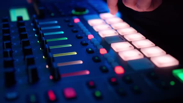 Professional DJ Plays Beat Sampler with Color Drum Pads and Samples in Studio