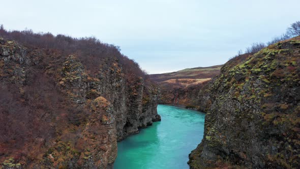 Drone Of Water Flowing Between Rocky Cliffs Of Canyon