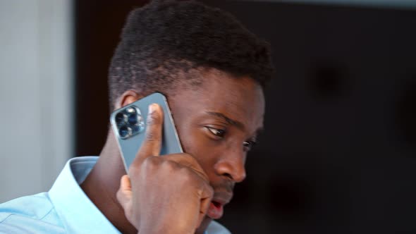 Portrait of young businessman having phone call