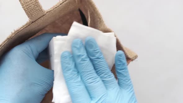 Hand in Latex Gloves Wapping a Gift Box with Tissue