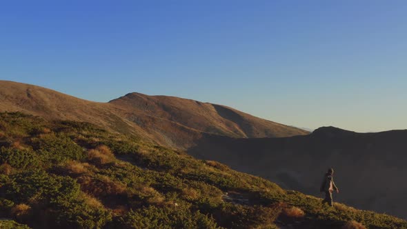 Aerial View of Hiker Man with Backpack on Ridge of a Mountain