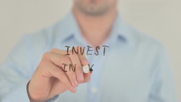 Invest in You, Man Writing on Transparent Glass Screen