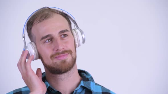 Face of Happy Bearded Hipster Man Listening To Music with Eyes Closed