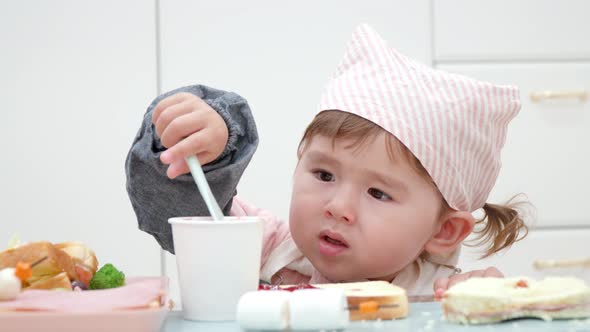 2-Year-Old Little Girl Spreading Jam On Her Sandwich. - close uo