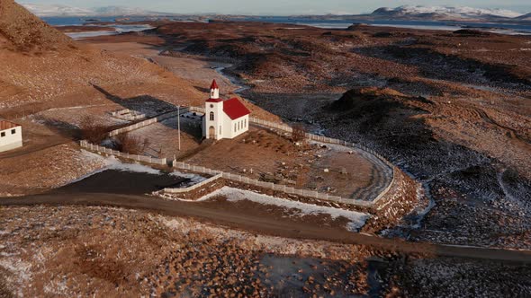 Drone Over Church On Landscape With Snow And Sunlight