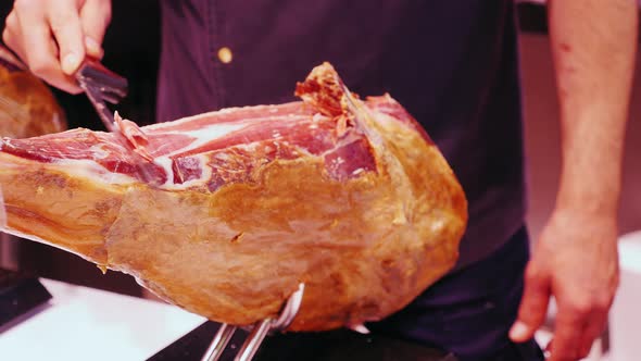 The Seller Cuts the Jamon Into Thin Slices