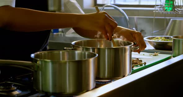 Chef preparing food in kitchen at restaurant 4k