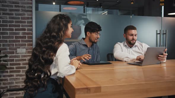 Three Business Partners Developing New Project Multinational Colleagues Smiling Chatting in