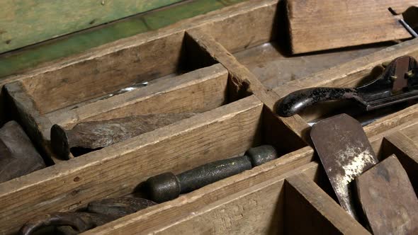 Panning view over old tools in chest