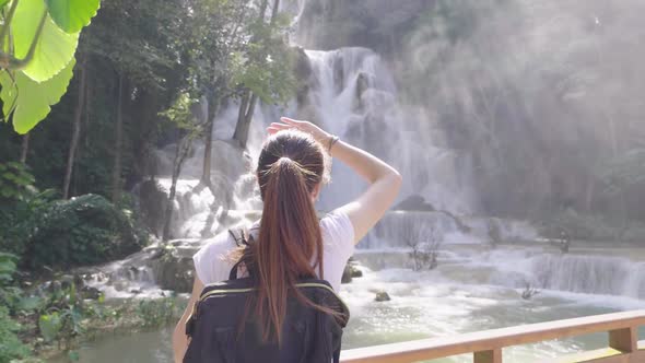 Travel Girl With Beautiful Light And Waterfall