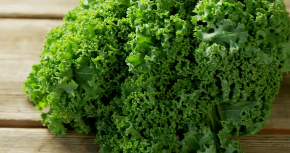 Green leafy vegetable on wooden floor