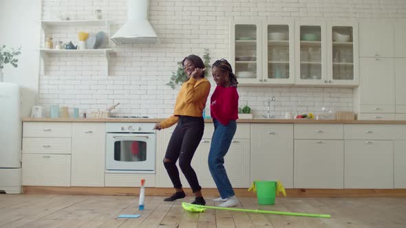 Cheerful African Sisters Enjoying Leisure After Cleanup