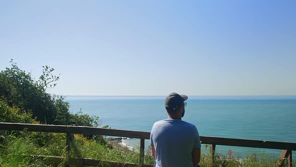 Guy Admires Endless Seascape