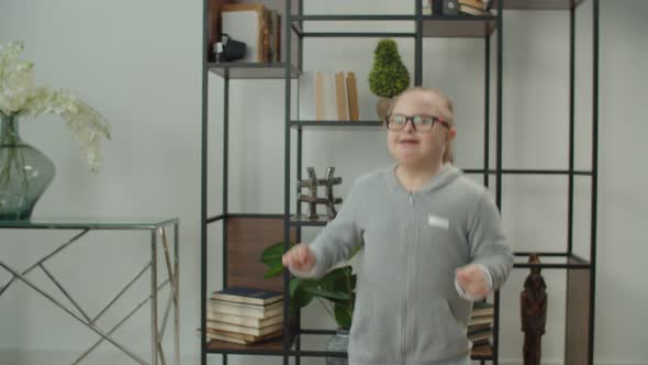 Cute Happy Girl with Down Syndrome Having Fun Indoors