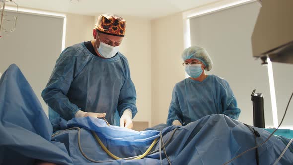 In the Hospital Operating Room Diverse Team of Professional Surgeons and Nurses