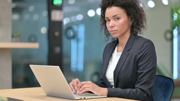 African Businesswoman Looking at Camera at Work