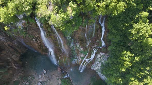 Top view of the beautiful Plitvice Lakes National Park in Croatia. Close-up of the waterfall filmed