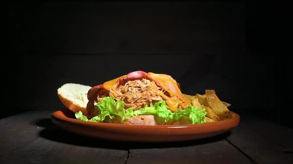 Slow Motion Fresh Onion Rings Falls on Pulled Pork Burger