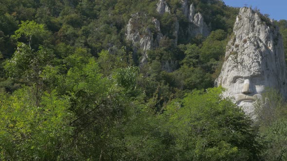 Natural environment Decebalus sculpture in stone 4K 2160p UHD video - Decebalus head  incised in sto