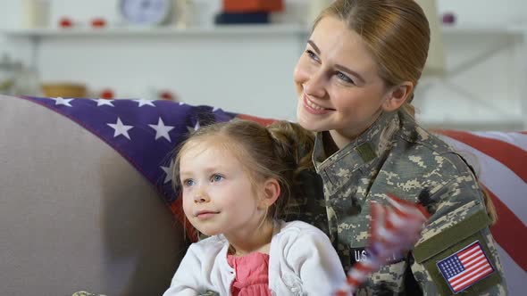 Happy Female Soldier and Daughter National Flag Watching Parade Together