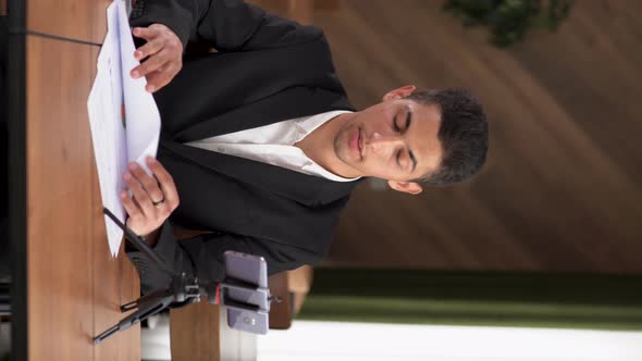 Young Business Arab an Influential Man Sitting in the Office Records a Video Blog on a Smartphone