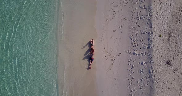 Fun boy and girl after marriage in love enjoy luxury on beach on sunny white sandy background 