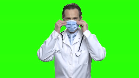 Portrait of Male Doctor Puts on Medical Protective Mask