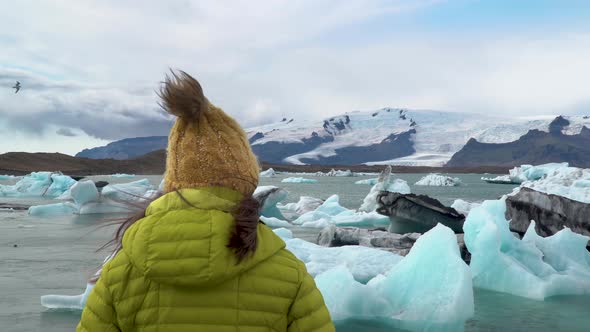 Tourist on Iceland Looking at Jokulsarlon Glacier Lagoon