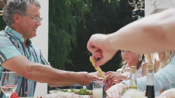 Happy family eating together at table