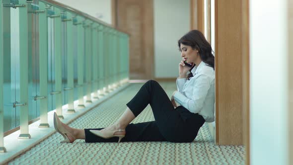 Business woman talking on the phone. Corridor.