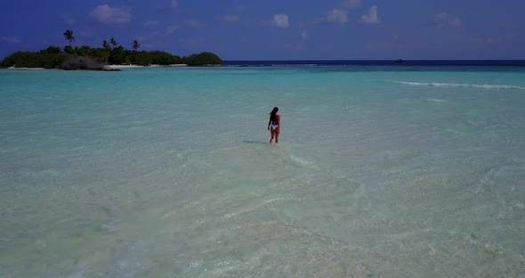 Modern Fun Woman on Vacation Enjoying Life on The Beach on Clean White Sand and Blue