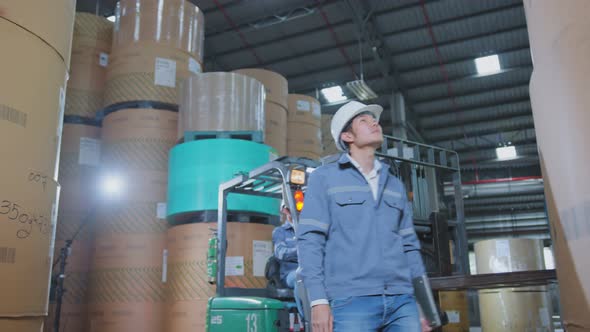 engineer staff male warehouse worker in hard hat working. walking through logistics center warehouse