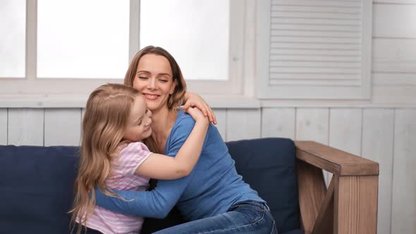 Cute Female Kid Cuddling Lovely Mom Having Happiness and Positive Emotion